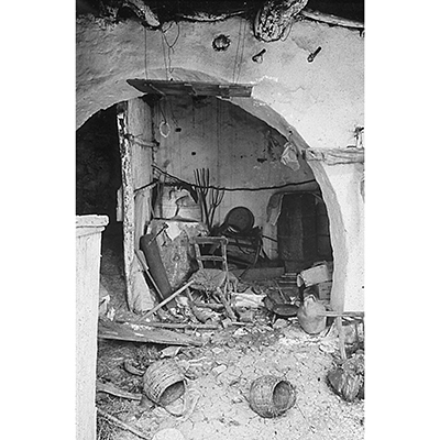 Black and white photo of Frontispiece. Interior of an abandoned house in East Crete (photograph by Christos Beltes).
