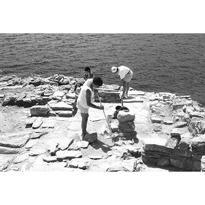 Black and white photo of Frontispiece. Excavating in Room AF 3A/B.