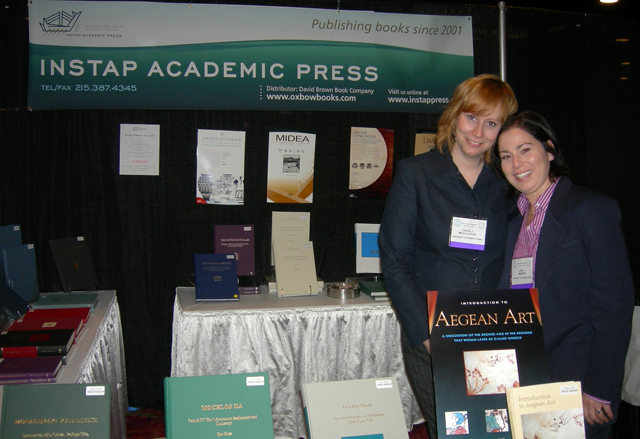 Color photo of volunteers at the exhibition booth.