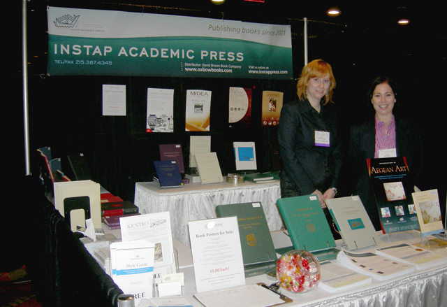 Color photo of volunteers at the exhibition booth.
