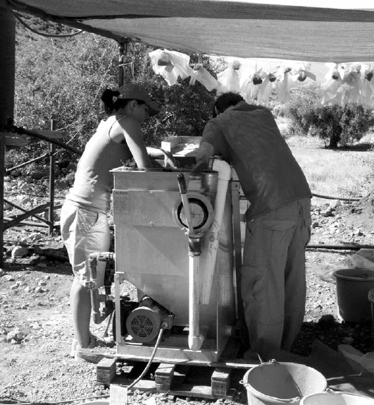 Black and white photo of Figure 10. Flote-Tech machine-assisted flotation device in use at Mycenae. Photo courtesy of Brooke Hundtoft.
