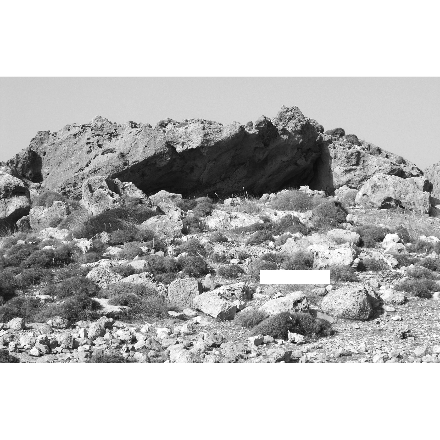 Black and white photo of Plate 8B. The tholos tomb and the rock shelter (Chamber 1) from the southeast.